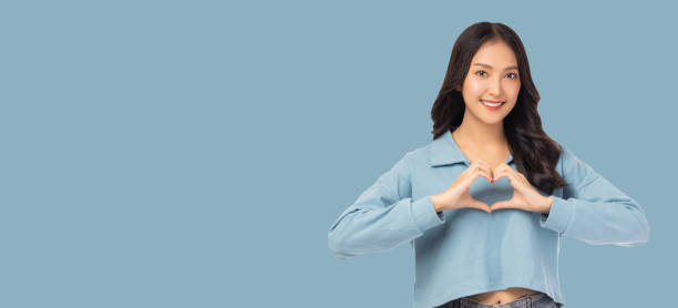 istock Smiling Woman Making Heart Gesture 2159672345