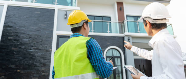 istock inspector engineer and owner project is inspecting construction and quality assurance new house. Engineers or architects or contactor work to build the house before handing it over to the homeowner 2159672875