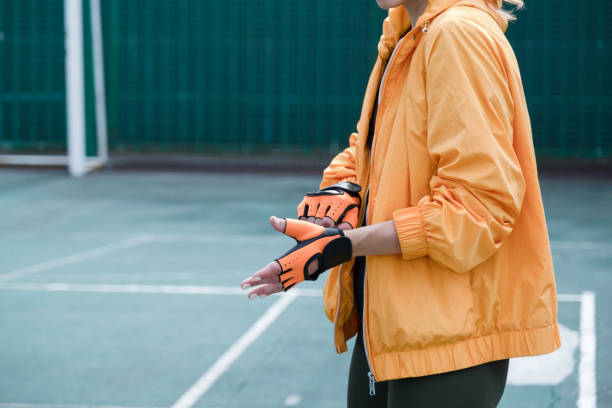 istock young female boxer training in the stadium putting on gloves 2159673046