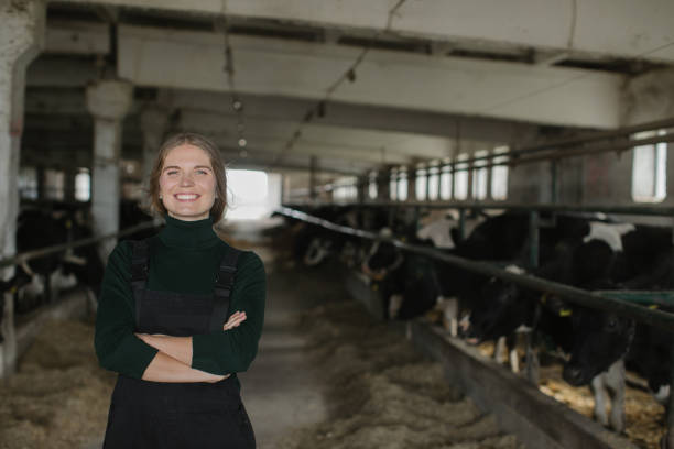 istock Woman farmer posing on cow dairy farm in cowshed 2159673368
