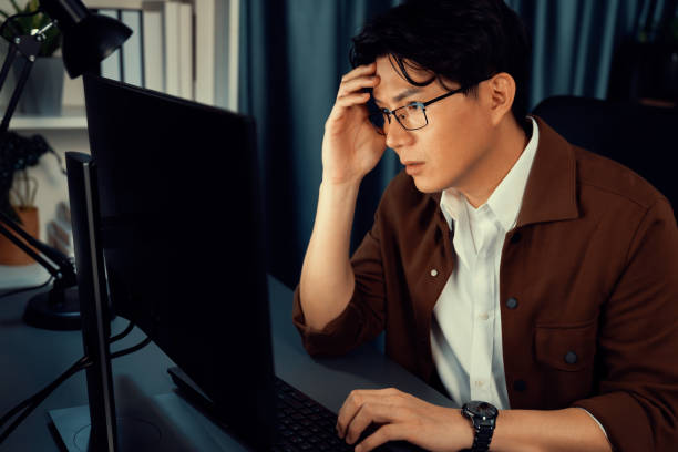 istock Businessman focusing computer business plan report over late night. Infobahn. 2159674703