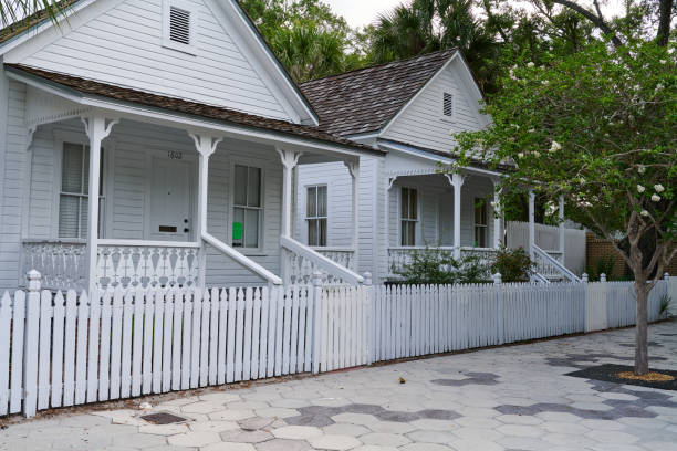 Key West, FL, USA-April 22, 2024; Typical architectural style houses on leafy palm tree streets in neighborhood Old Town Key West