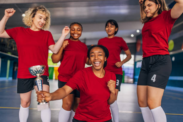 istock Victorious team cheers together with trophy at center 2159675020