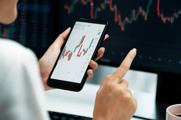 istock Cropped businesswoman using phone in profitable comparing with pc. Stratagem. 2159675547