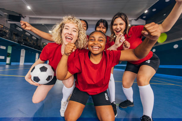 istock Women in red shirts celebrating a team victory 2159676145