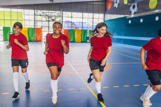istock Women soccer players running during team practice. 2159676299