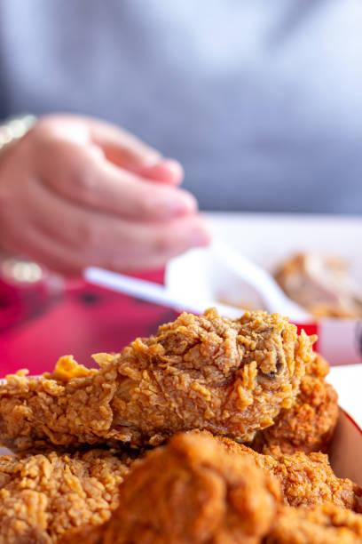 istock Fried chicken with blur women eating background 2159677484