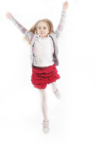 little girl jumps on a white background