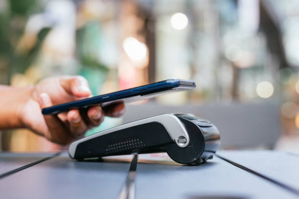 istock man paying contactless with mobile phone in restaurant. 2159678486