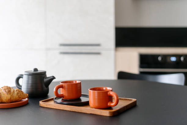 istock Selective focus on bamboo board with cups, teapot and plate with bakery on table 2159681997