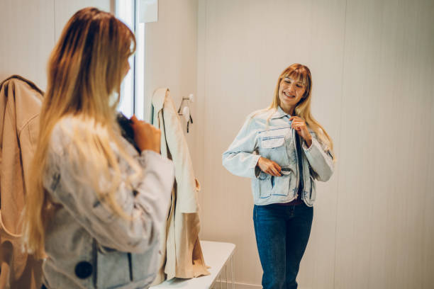 istock Young woman trying clothes in a dressing room 2159682415