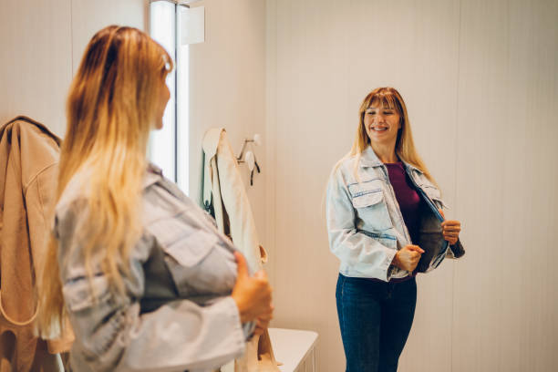 istock Young woman trying clothes in a dressing room 2159685066