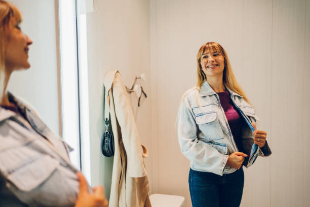 istock Young woman trying clothes in a dressing room 2159685265