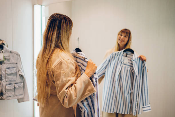 istock Young woman trying clothes in a dressing room 2159685379