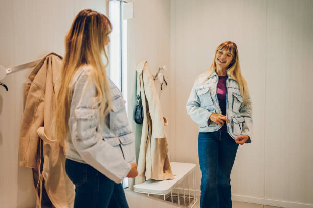 istock Young woman trying clothes in a dressing room 2159685455