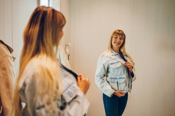 istock Young woman trying clothes in a dressing room 2159685486
