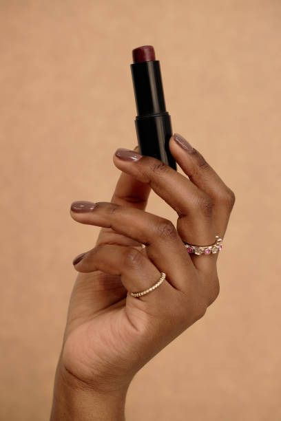istock Red Lipstick in Girls Hand 2159685978