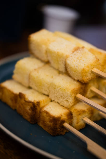 istock Slightly golden toast cut square, just the right size put in a stick 2159687910
