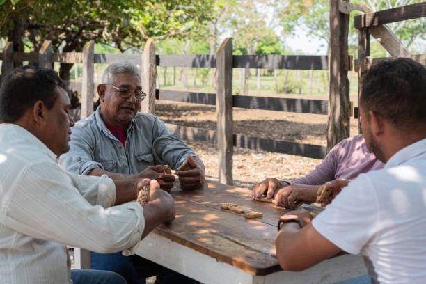 istock Friends Playing Dominoes Outdoors in Rural Setting 2159688260
