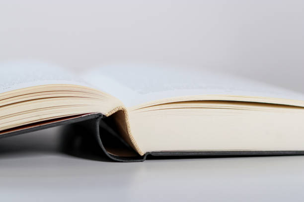istock Close up of an open book on white table, blurred background 2159688637