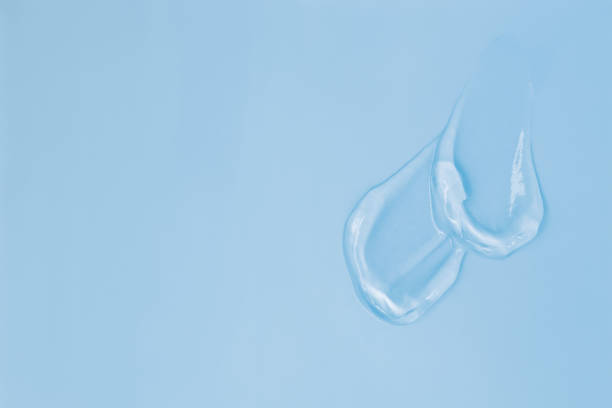 istock Gel smears cosmetic texture on blue background with space for text 2159689310