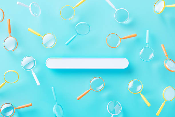 Colorful magnifiers and search box over blue background. Horizontal composition. Search concept.