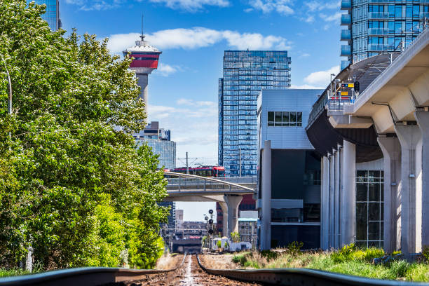 istock Low rail view of tracks entering downtown next to elevated transit platform 2159690996