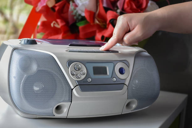 cd player using Homeowner is pressing play panel of the cd deck with his fingers to play music from his favorite cd player unit, vintage concept, soft and selective focus. open cd player stock pictures, royalty-free photos & images