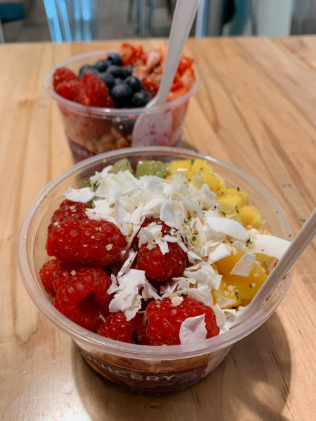 Fresh & Colorful Fruit Acai Bowl with Strawberries, Kiwi, Mango, Blueberries, Coconut Flakes, Chia Seeds, Hemp Hearts & Granola at a Local Green Market in West Palm Beach, FL
