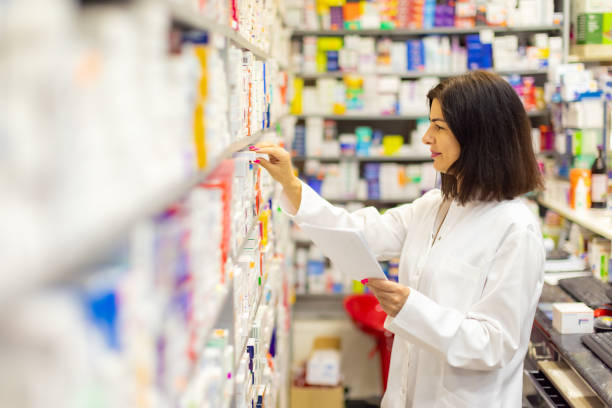 istock Young Caucasian female pharmacist doing inventory at the pharmacy 2159693225