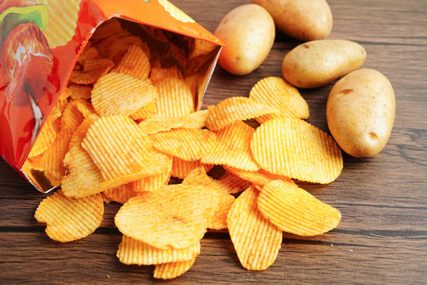 istock Potato chips in open bag, delicious BBQ seasoning spicy for crips, thin slice deep fried snack fast food. 2159696195