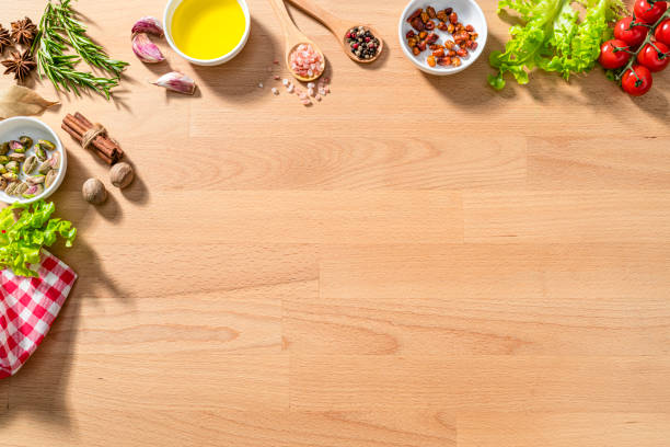 Culinary border of herbs and spices on kitchen table top. Copy space