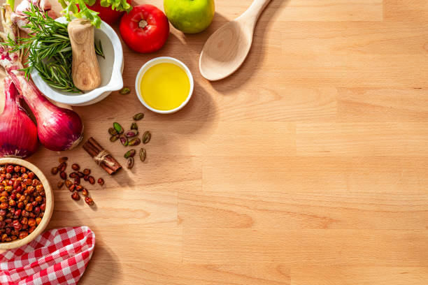 istock Cooking ingredients border on wooden kitchen counter background. Copy space 2159697513