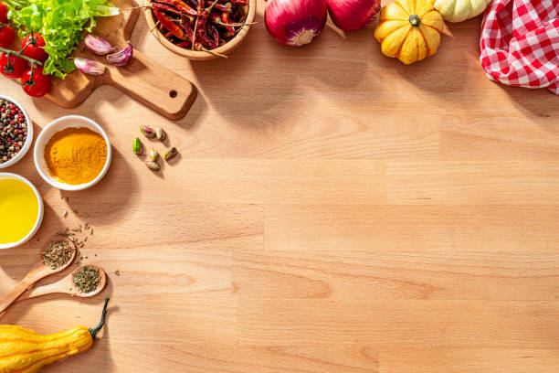 istock Herbs, spices and vegetables border on wooden kitchen counter. Copy space 2159697529