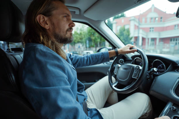 istock Handsome man driving in the city 2159699227