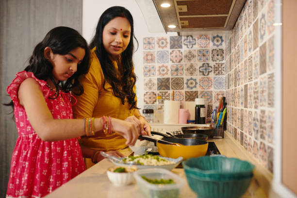 istock Daughter Helping Her Mom To Cook 2159699314