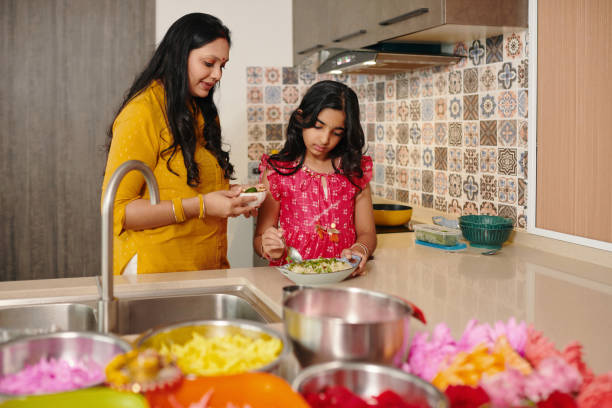 istock Mom Teaching Her Daughter To Cook 2159699647