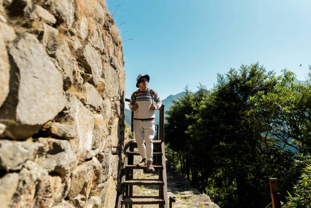 istock Mature man looking around moving down on staircase on Machu Picchu, in Peru 2159699662