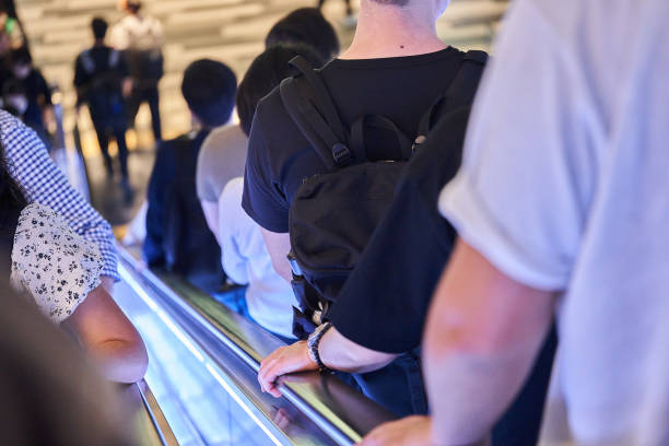 Lots of people walking on escalators