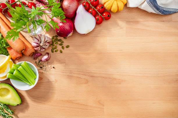 istock Healthy fresh vegetables border on wooden kitchen counter. Copy space 2159700503