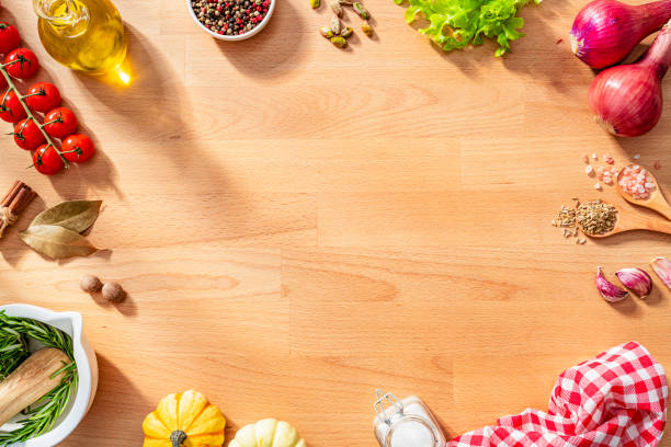 istock Herbs, spices and vegetables border on wooden kitchen counter. Copy space 2159700506