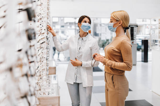 istock Young adult woman buying eyeglasses 2159701607