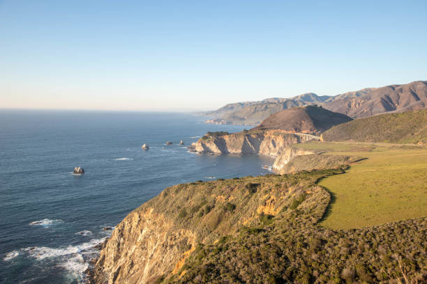 istock Big Sur, California, sunset, adventure, breathtaking, landscape, Pacific Coast, scenic, rugged cliffs, ocean views, golden hour, dramatic, coastline, natural beauty, Highway 1, serene, panoramic, vistas, picturesque, vibrant colors, 2159701632