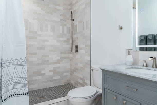 istock modern bathroom white with gray tile shower, cabinet, and sink 2159701880
