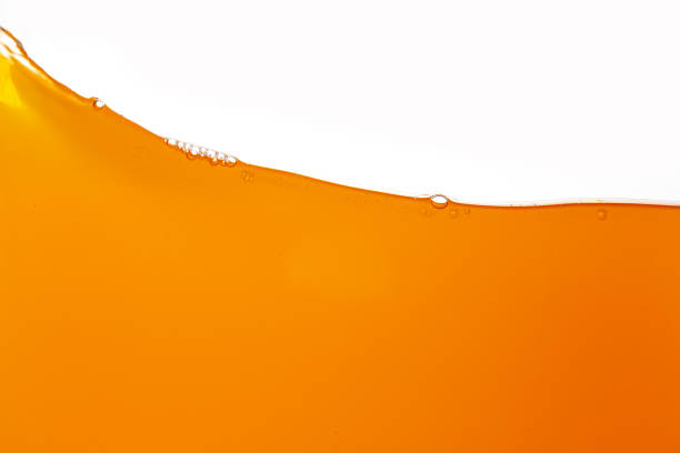 istock orange juice texture isolated white background,Close up bright orange juice texture for health and nature waves 2159705010