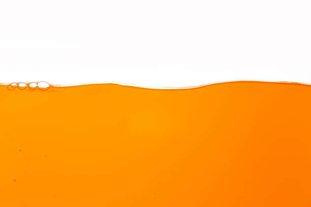 istock orange juice texture isolated white background,Close up bright orange juice texture for health and nature waves 2159705012