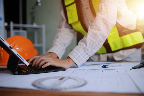 istock engineer people meeting working and pointing at a blueprint in office for discussing. Engineering tools and construction concept 2159705207