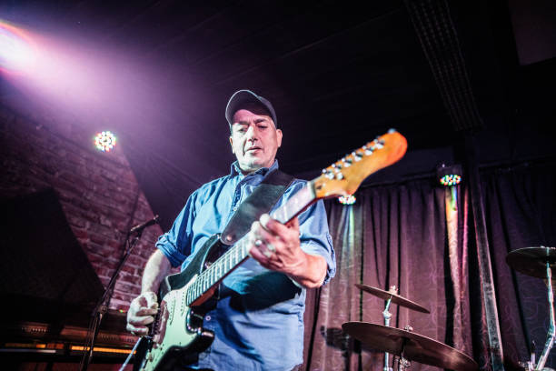 istock Mature man playing electric guitar on stage 2159707367
