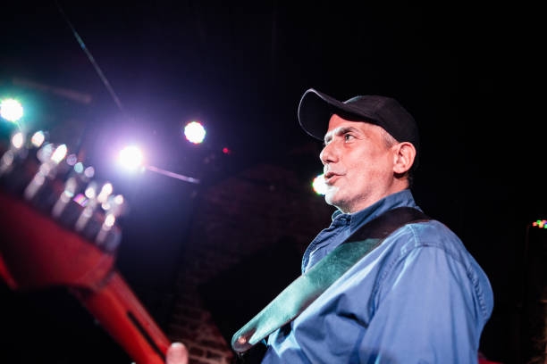 istock Mature man playing electric guitar on stage 2159707376