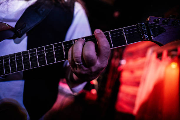 istock Close-up of man playing electric guitar on stage 2159707501